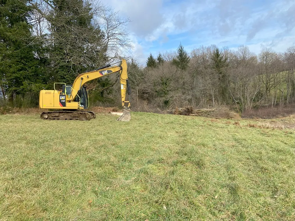Digger about to dig out the fishing lake in france